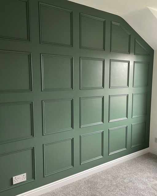 This picture depicts a feature panelled wall in a bedroom
